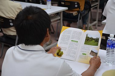 與會農友詳細閱讀本場印製之「柚類果樹復耕技術」推廣文宣
